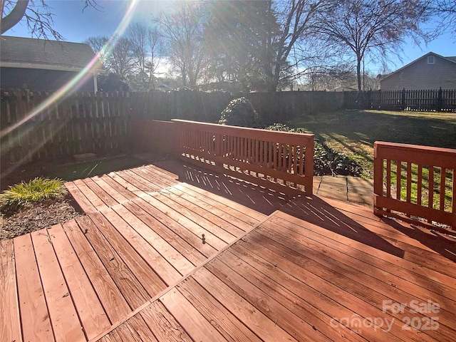 wooden terrace featuring a fenced backyard