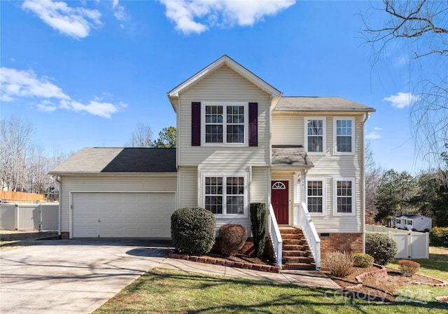 traditional-style home with an attached garage, crawl space, a gate, fence, and driveway