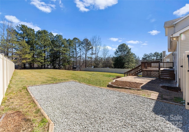 view of yard featuring a fenced backyard, a patio, a deck, and stairs