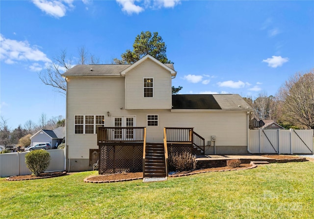 back of house featuring a gate, a yard, a wooden deck, and fence