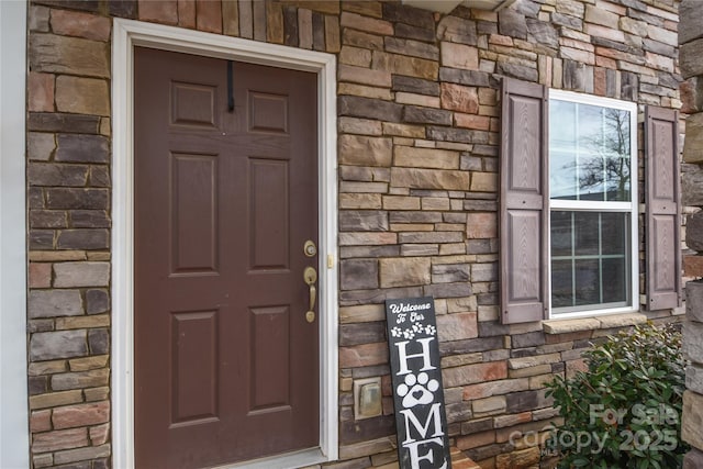 view of exterior entry with stone siding