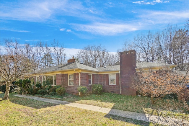 single story home with crawl space, brick siding, a chimney, and a front lawn