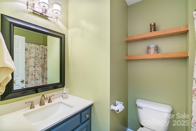 bathroom featuring vanity and toilet