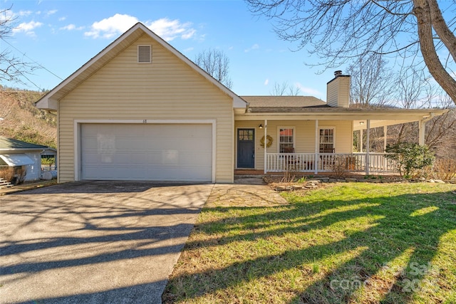 view of front facade featuring covered porch, a garage, driveway, a front lawn, and a chimney