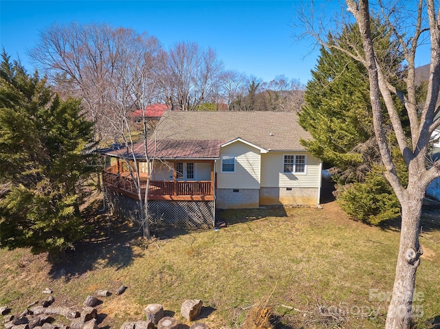 rear view of house with crawl space, a shingled roof, a lawn, and a wooden deck