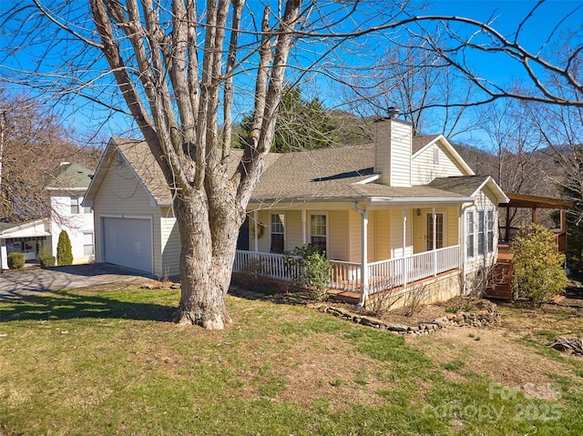 view of front of home featuring roof with shingles, a porch, a chimney, and a front yard