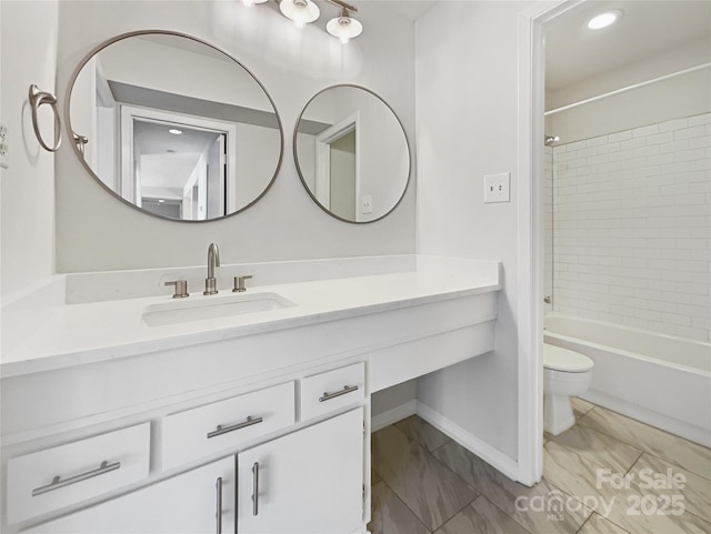 full bathroom featuring toilet, vanity, baseboards, marble finish floor, and tub / shower combination