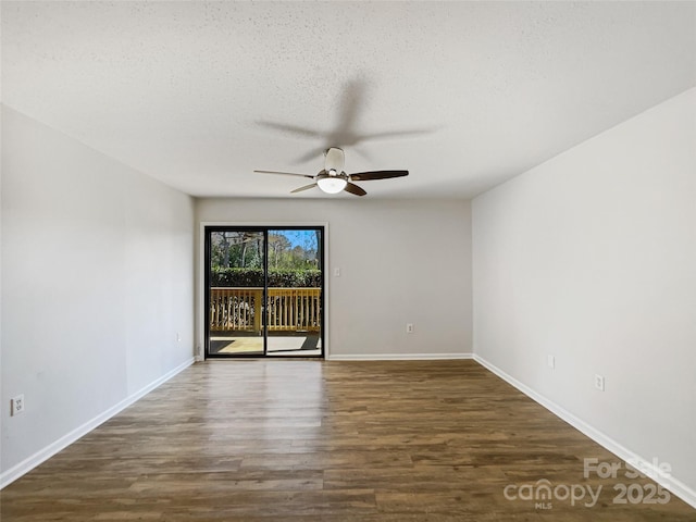 unfurnished room featuring a textured ceiling, wood finished floors, and baseboards