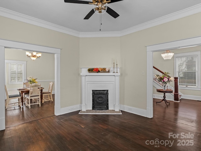 living room with crown molding, stairway, and hardwood / wood-style floors