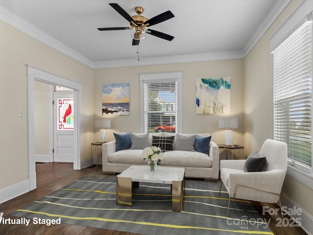 sitting room with ceiling fan, crown molding, baseboards, and wood finished floors