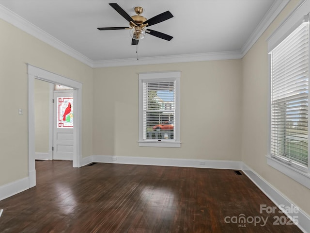 empty room with crown molding, wood finished floors, and a healthy amount of sunlight