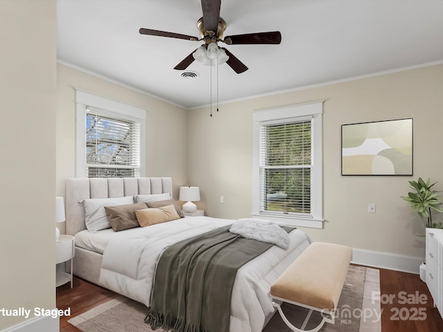 bedroom featuring ornamental molding, wood finished floors, and visible vents