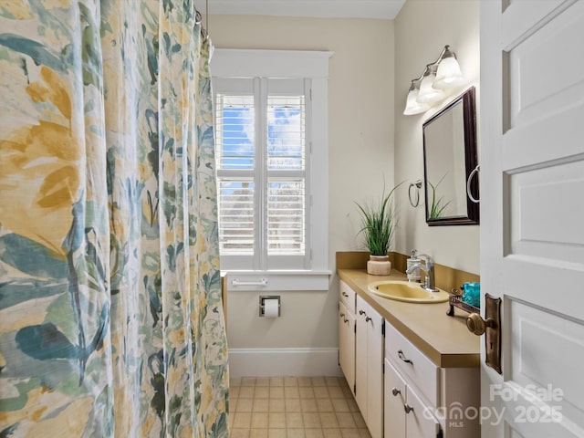 bathroom with a shower with curtain, tile patterned flooring, baseboards, and vanity