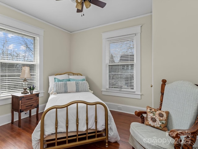 bedroom featuring crown molding, baseboards, and wood finished floors