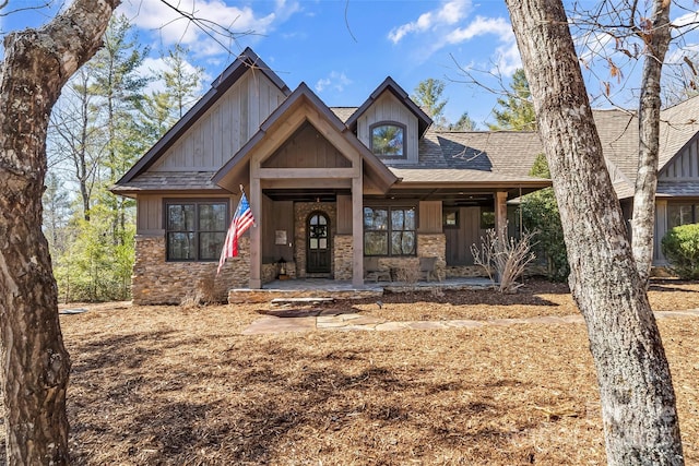 craftsman-style home featuring stone siding and a shingled roof