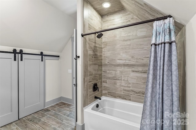 full bathroom featuring shower / bath combination with curtain, wood finish floors, and vaulted ceiling