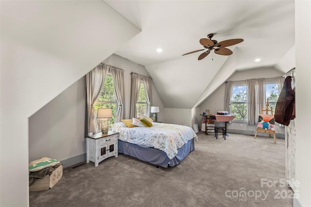 bedroom featuring carpet floors, multiple windows, baseboards, and vaulted ceiling