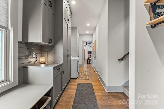 interior space featuring light wood-style floors, recessed lighting, stairway, and baseboards