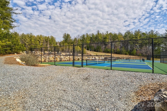 view of sport court featuring fence