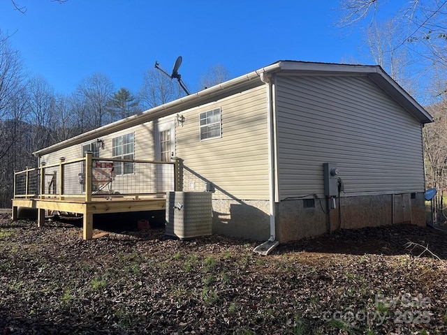 back of house with a wooden deck