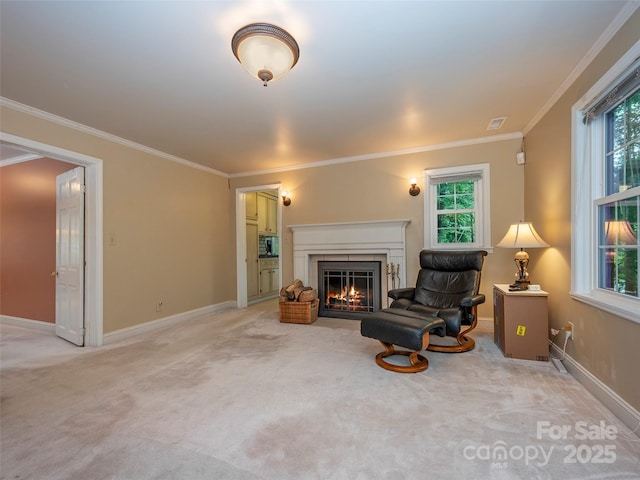 living area featuring light colored carpet, baseboards, a lit fireplace, a wealth of natural light, and crown molding