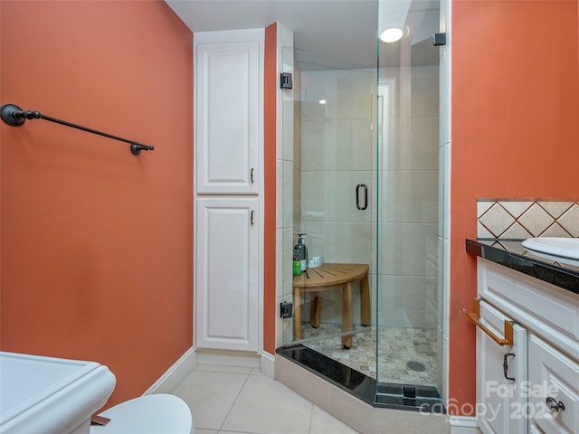 full bath with toilet, a stall shower, tile patterned flooring, and vanity