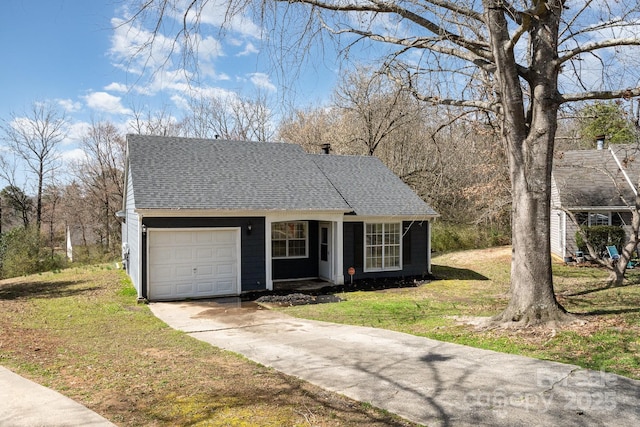 view of front facade with an attached garage, driveway, a shingled roof, and a front yard