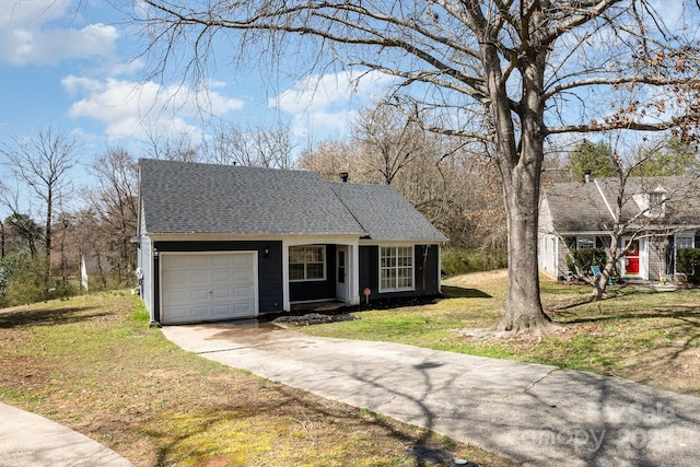 view of front of property with a garage, driveway, a front lawn, and roof with shingles