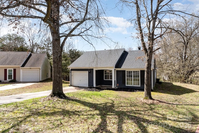 view of front of home with a shingled roof and a front yard