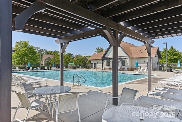 pool featuring a patio area, fence, and a pergola