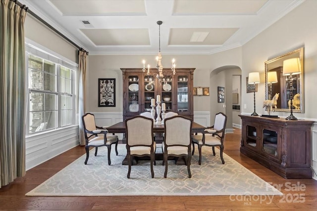 dining room with arched walkways, a chandelier, coffered ceiling, wood finished floors, and visible vents