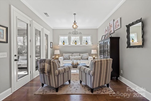 living area featuring dark wood-style flooring, visible vents, crown molding, and baseboards