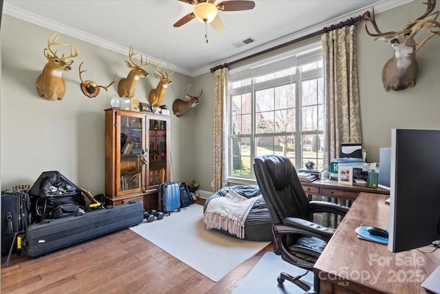 office area with a ceiling fan, visible vents, crown molding, and wood finished floors