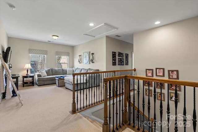 interior space featuring carpet floors, attic access, visible vents, and recessed lighting