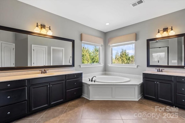 bathroom featuring two vanities, a sink, visible vents, and tile patterned floors