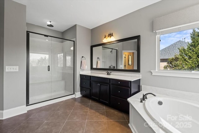 full bathroom with a stall shower, a garden tub, vanity, and tile patterned floors