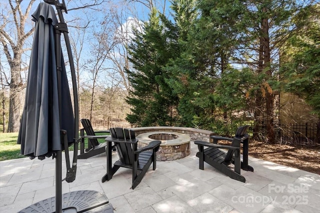 view of patio / terrace with a fire pit and fence