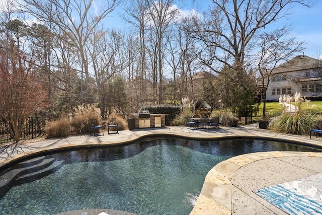 pool featuring a patio area, outdoor dining area, area for grilling, and fence