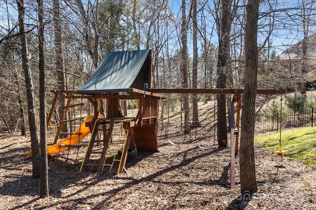 view of jungle gym featuring fence