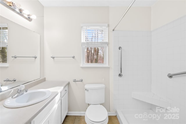 full bathroom with baseboards, tiled shower, toilet, tile patterned floors, and vanity