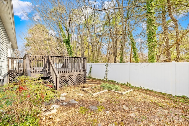 view of yard with a deck and a fenced backyard