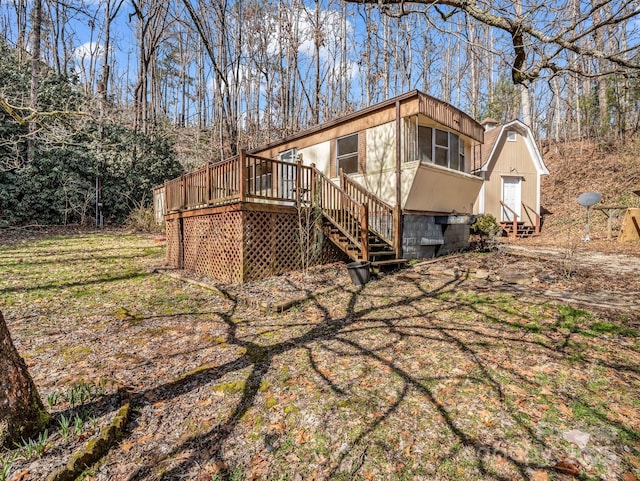 rear view of house featuring entry steps and a deck