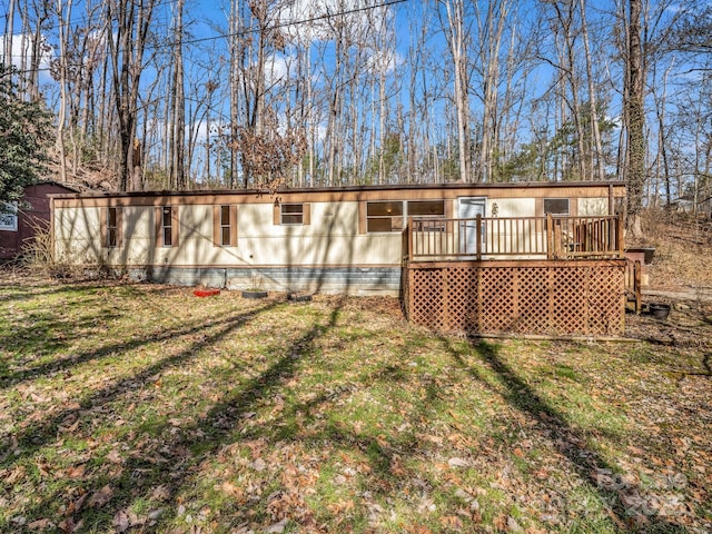 rear view of property with a yard and a deck