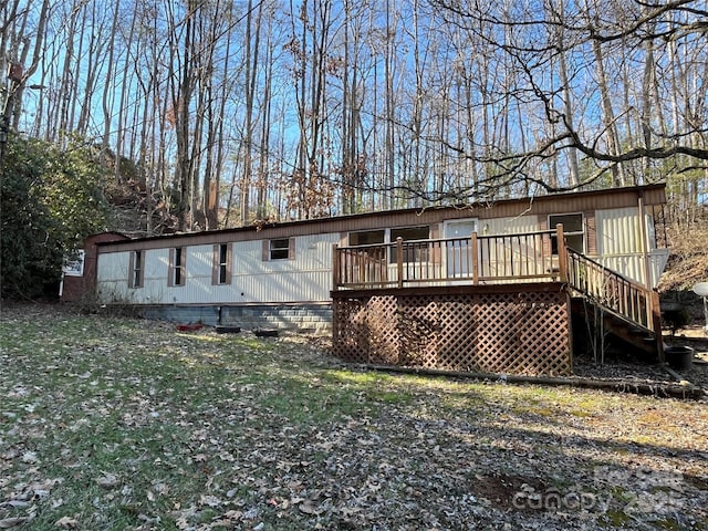 rear view of house featuring a deck