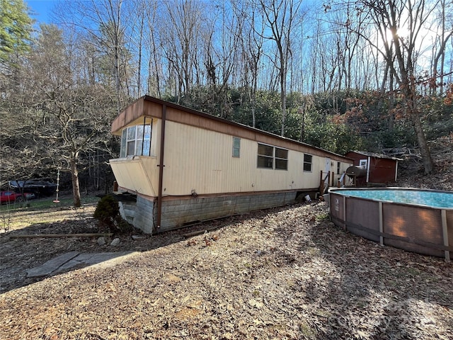 view of side of home with an outdoor pool