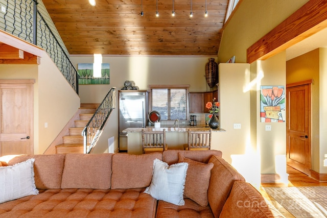 living area with visible vents, stairway, high vaulted ceiling, wooden ceiling, and baseboards