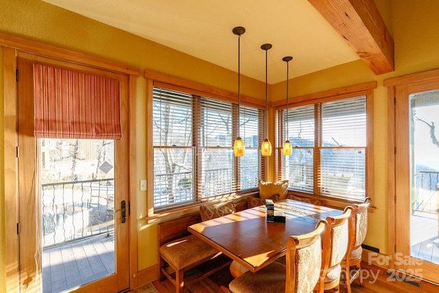 dining area featuring beamed ceiling