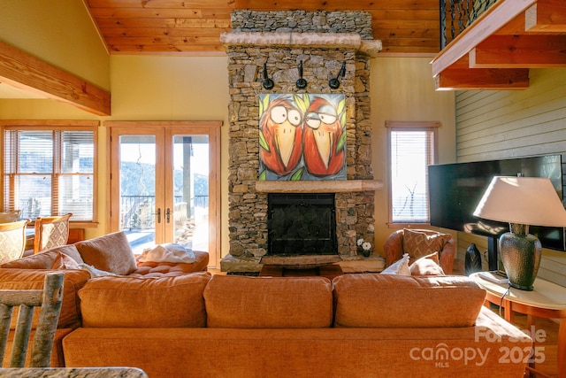 living room with wood ceiling, a fireplace, vaulted ceiling, and french doors