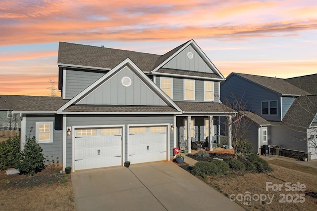 traditional-style house featuring driveway, a shingled roof, a garage, and board and batten siding