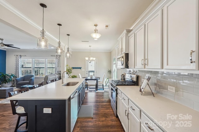 1426 Whitman Ct, York, SC 29745 - kitchen with appliances with stainless steel finishes, open floor plan, a kitchen breakfast bar, backsplash, and white cabinets